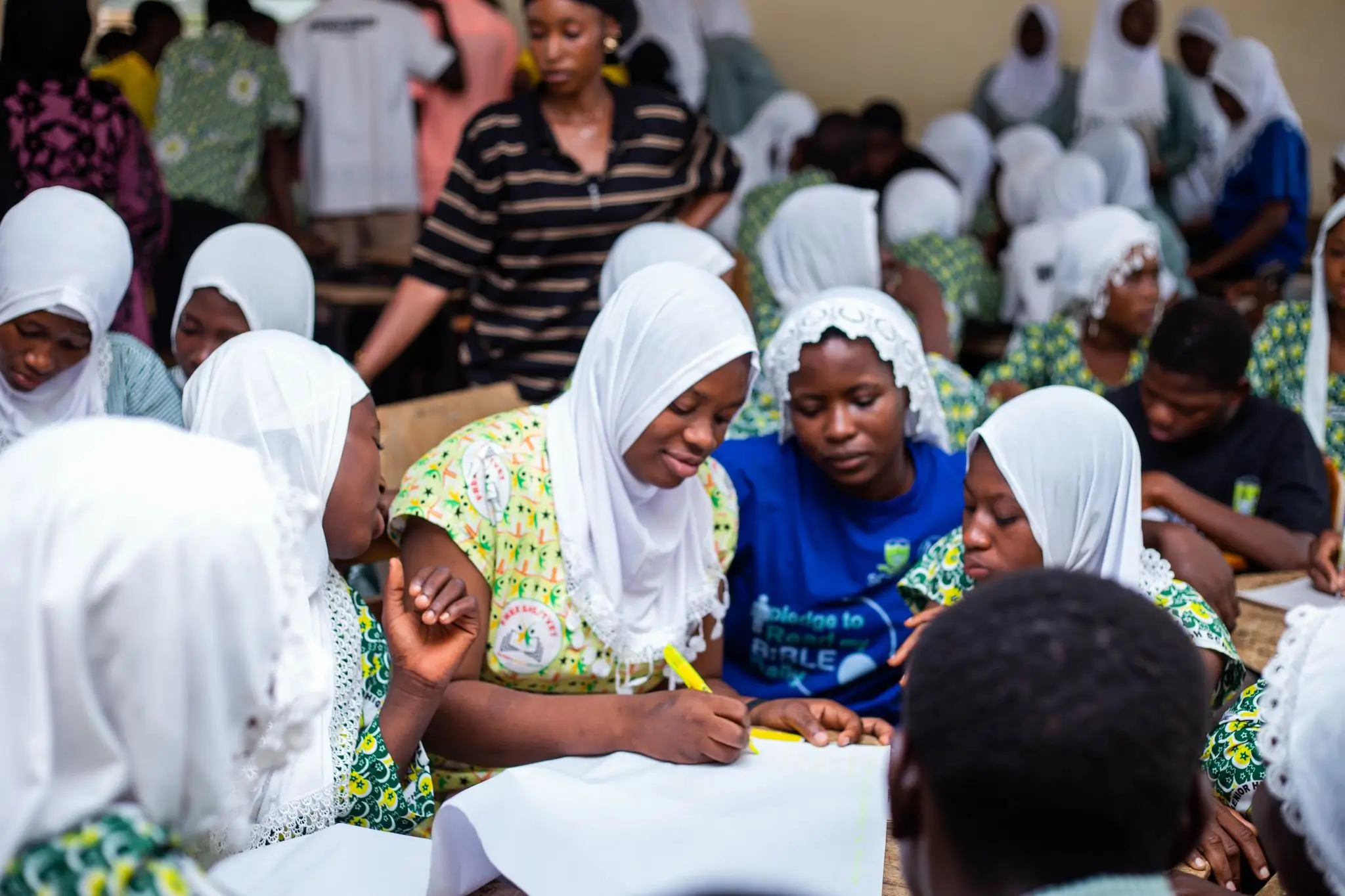 Young women and secondary-school students engaging with digital learning