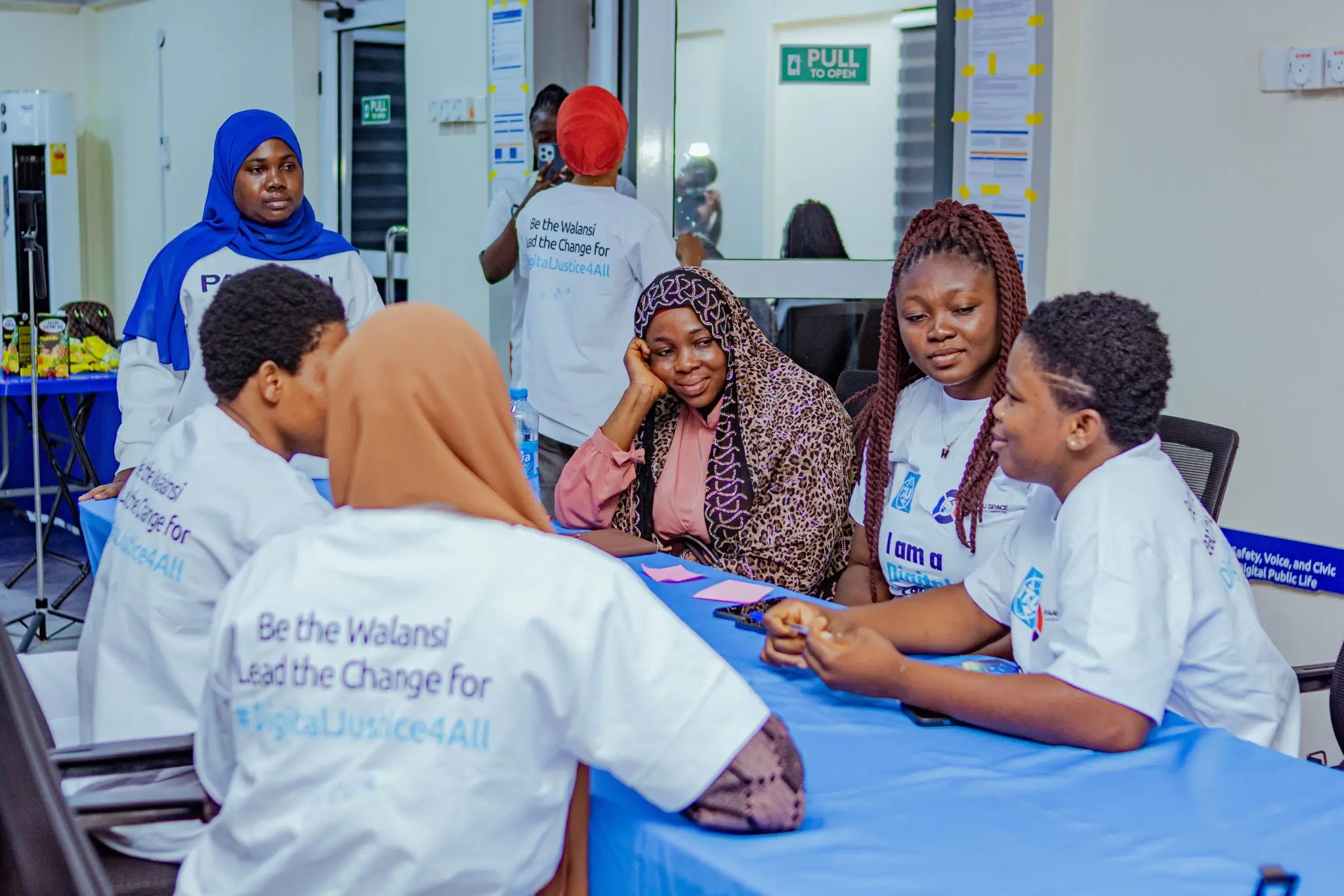 Young women leading digital safety and AI literacy sessions in their own communities